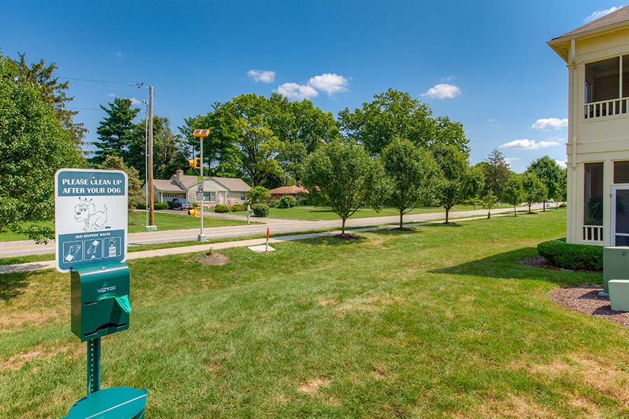 A serene and clean dog park is a great place to be with your pup, just like the one at Stonebridge Apartments. Dog park with a sign and complementary waste bags located at Stonebridge apartments.