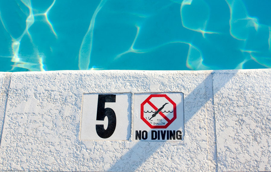 Up close shot of the pool's no diving sign.